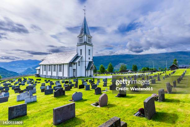 norway, viken, gol, rows of tombstones with rural church in background - gol stock pictures, royalty-free photos & images