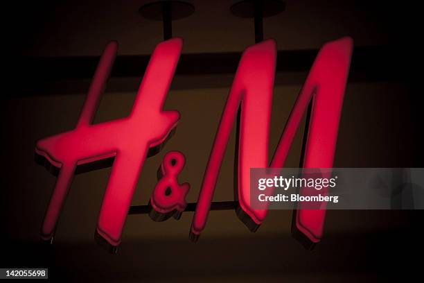 An illuminated logo sits outside an Hennes & Mauritz AB store in Malmo, Sweden, on Thursday, March 29, 2012. Hennes & Mauritz AB, Europe's...