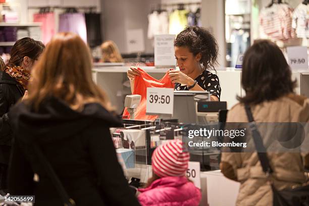 Customers browse clothing for sale inside an Hennes & Mauritz AB store in Malmo, Sweden, on Thursday, March 29, 2012. Hennes & Mauritz AB, Europe's...