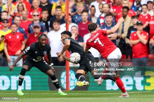 Lloyd Kelly of Bournemouth has a penalty awarded against him after Neco Williams of Nottingham Forest fires in a shot during the Premier League match...