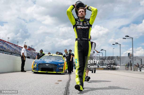 Ryan Blaney, driver of the Menards/Moen Ford, walks the grid in preparation to qualify for the NASCAR Cup Series Cook Out Southern 500 at Darlington...