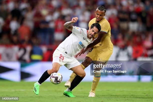 Isco of Sevilla FC is marked by Jules Kounde of FC Barcelona during the LaLiga Santander match between Sevilla FC and FC Barcelona at Estadio Ramon...