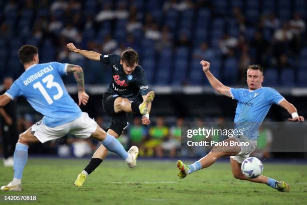 Khvicha Kvaratskhelia of Napoli is challenged by Patric of SS Lazio during the Serie A match between SS Lazio and SSC Napoli at Stadio Olimpico on...