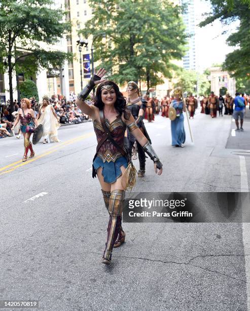 Cosplayer dressed as Wonder Woman walk in the 2022 Dragon Con Parade on September 03, 2022 in Atlanta, Georgia.
