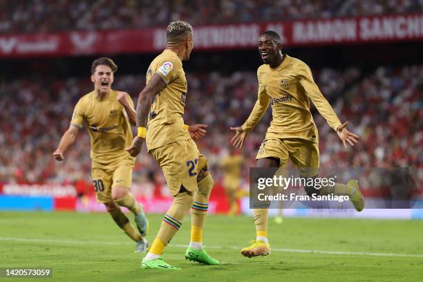Raphinha of FC Barcelona celebrates scoring their side's first goal with teammates during the LaLiga Santander match between Sevilla FC and FC...