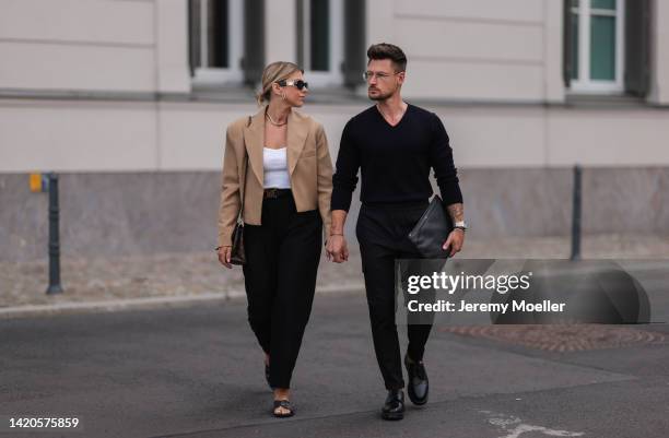 Aline Kaplan wearing Zara blazer, Zara top, Weekday trousers, Louis Vuitton bag, H&M belt & shoes and Andre Hellmundt wearing Sandro Paris shoes,...