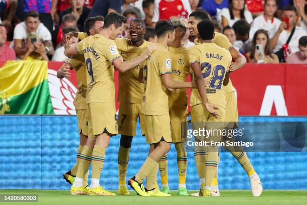 Eric Garcia of FC Barcelona celebrates scoring their side's third goal with teammates during the LaLiga Santander match between Sevilla FC and FC...
