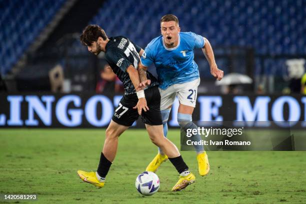 Sergej Milinković-Savić of SS Lazio and Khvicha Kvaratskhelia of SSC Napoli compete for the ball during the Serie A match between SS Lazio and SSC...