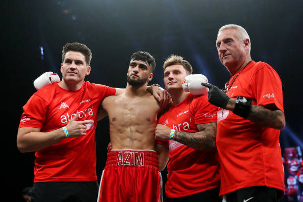 Adam Azim poses for a photograph with their team after defeating Michel Cabral in the 10x3 Super-Lightweight fight at M&S Bank Arena on September 03,...