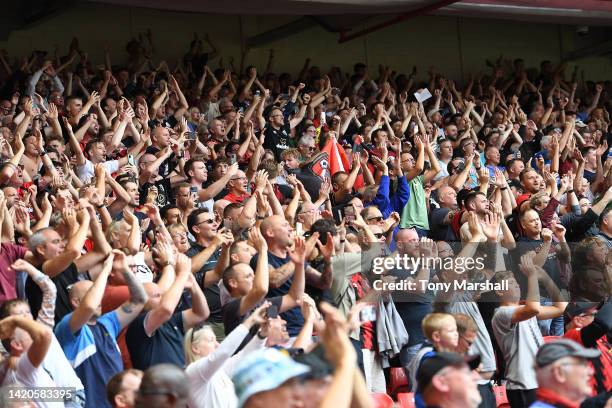 Fans of AFC Bournemouth celebrates their teams win after the final whistle during the Premier League match between Nottingham Forest and AFC...