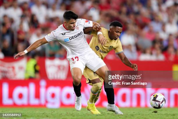 Marcos Acuna of Sevilla FC challenges Ansu Fati of FC Barcelona during the LaLiga Santander match between Sevilla FC and FC Barcelona at Estadio...