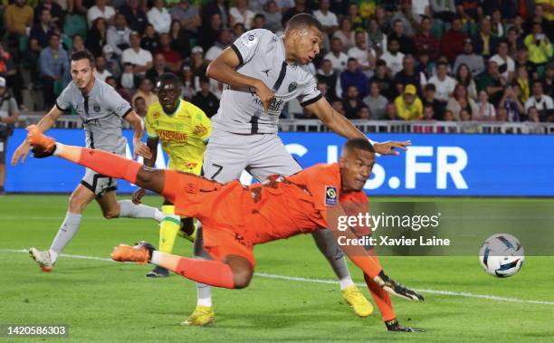 Kylian Mbappe of Paris Saint-Germain in action with Alban Lafont of Nantes during the Ligue 1 match between FC Nantes and Paris Saint-Germain at...