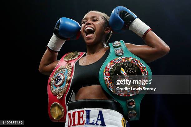 Natasha Jonas celebrates as they pose for a photograph with their title belts after their victory after defeating Patricia Berghult during the 10x2...