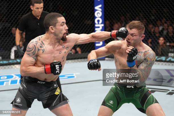 Robert Whittaker of New Zealand punches Marvin Vettori of Italy in a middleweight fight during the UFC Fight Night event at The Accor Arena on...