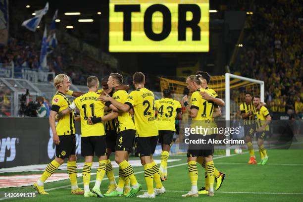 Marco Reus of Borussia Dortmund celebrates their team's first goal with teammates during the Bundesliga match between Borussia Dortmund and TSG...