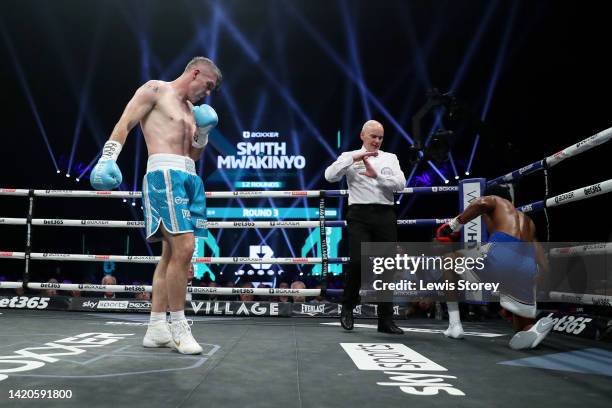 Liam Smith looks on as Hassan Mwakinyo goes down with an injury during the 12x3 Super-Welterweight fight between Liam Smith and Hassan Mwakinyo at...
