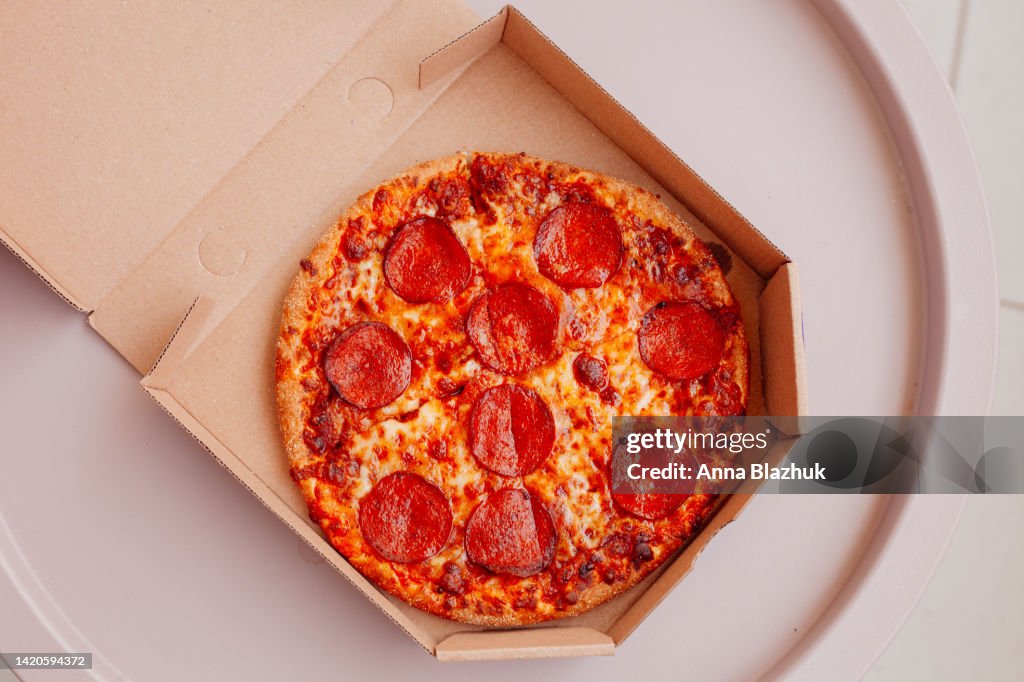 Pizza with pepperoni in box