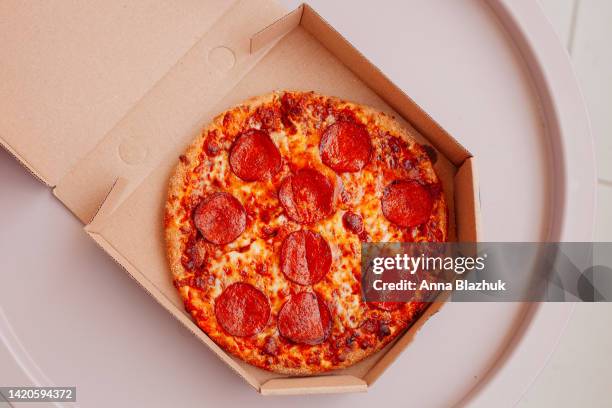 pizza with pepperoni in box - pepperoni pizza stock pictures, royalty-free photos & images