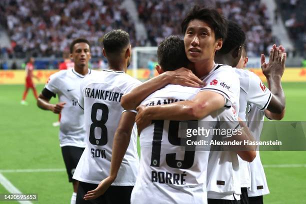 Rafael Santos Borre Maury of Frankfurt celebrates scoring the 4th team goal with his team mate Daichi Kamada during the Bundesliga match between...