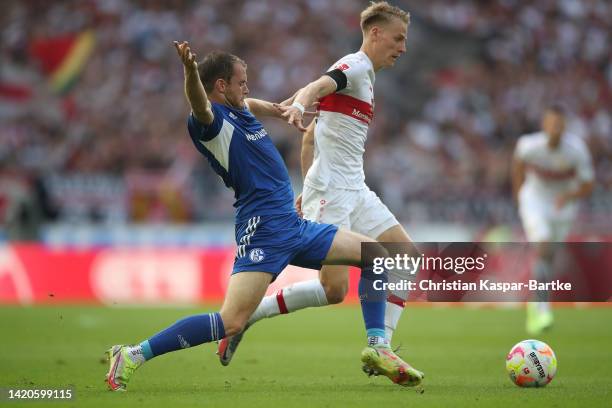 Chris Fuehrich of VfB Stuttgart challenges Thomas Ouwejan of FC Schalke 04 during the Bundesliga match between VfB Stuttgart and FC Schalke 04 at...