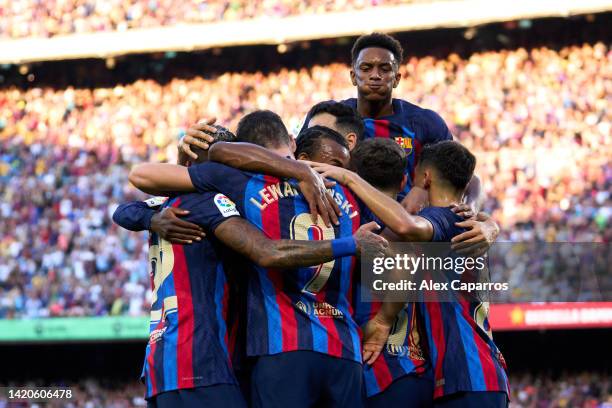 Robert Lewandowski of FC Barcelona celebrates with teammates after scoring the opening goal during the LaLiga Santander match between FC Barcelona...