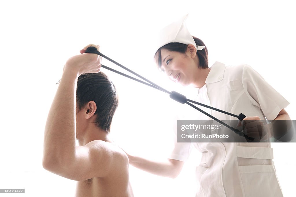 Young nurse helping male patient