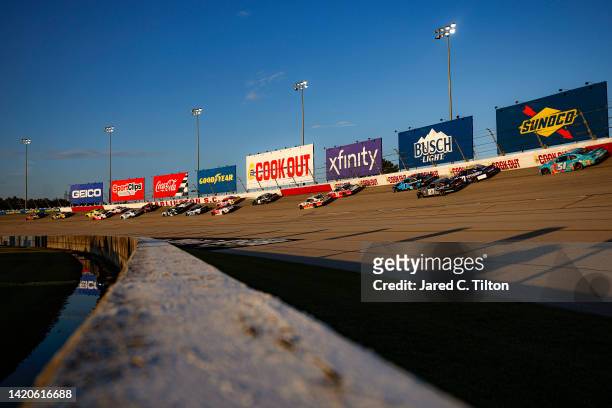 General view of racing as the sun sets during the NASCAR Xfinity Series Sport Clips Haircuts VFW Help A Hero 200 at Darlington Raceway on September...