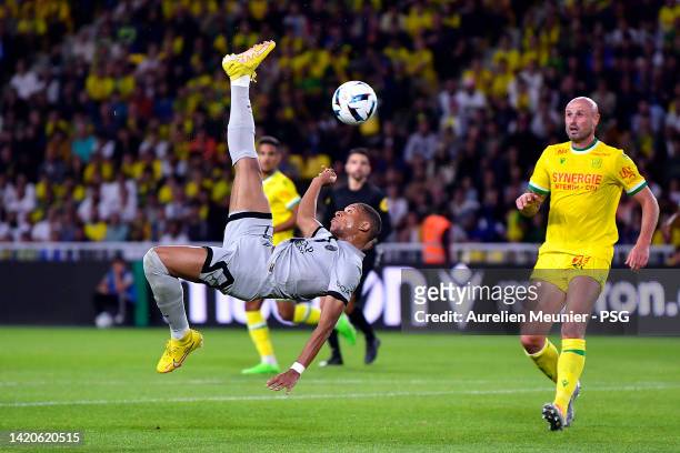 Kylian Mbappe of Paris Saint-Germain makes an acrobatic kick during the Ligue 1 match between FC Nantes and Paris Saint-Germain at Stade de la...