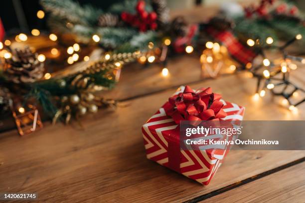 christmas gift box, food decor and fir tree branch on wooden table. top view with copy space - クリスマスプレゼント ストックフォトと画像