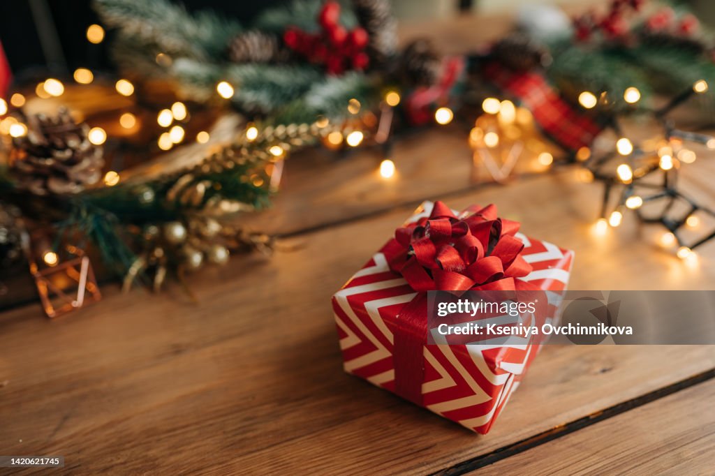 Christmas gift box, food decor and fir tree branch on wooden table. Top view with copy space