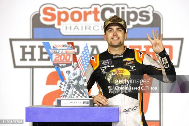 Noah Gragson, driver of the Bass Pro Shops/TrueTimber/BRCC Chevrolet, celebrates in victory lane after winning the NASCAR Xfinity Series Sport Clips...