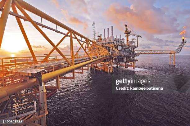 sunset of an offshore oil rig platform - flare stack stock pictures, royalty-free photos & images