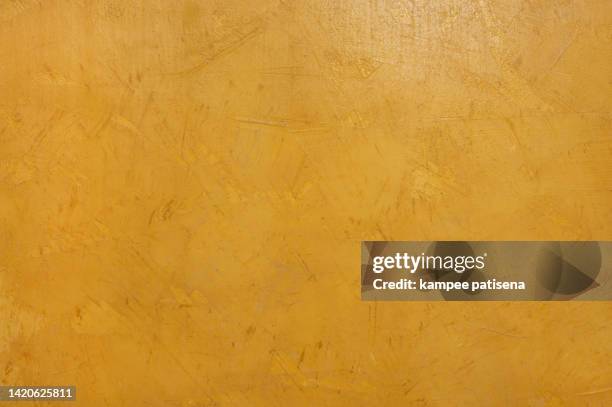 a background of a plain yellow wall - yellow wall stock-fotos und bilder