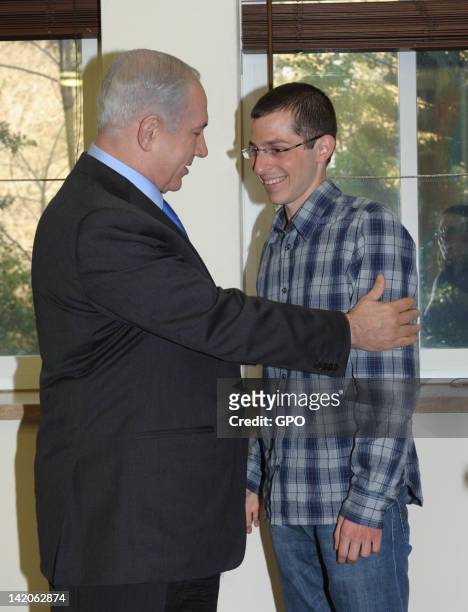 In this handout image provided by the Israeli Government Press Office , Israeli Prime Minister Benjamin Netanyahu meets with Gilad Shalit five months...
