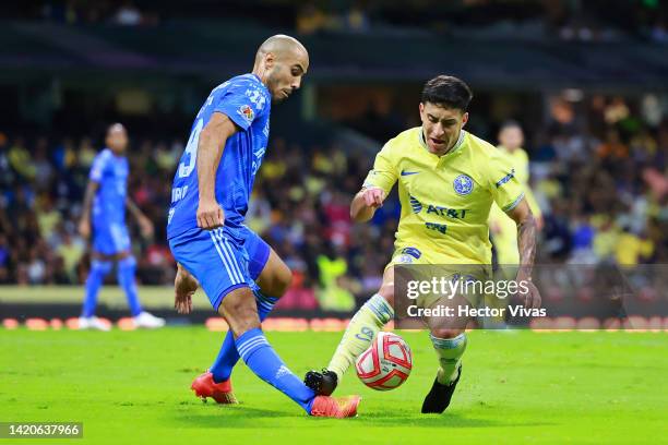 Guido Pizarro of Tigres battles for possession with Alejandro Zendejas of America during the 12th round match between America and Tigres UANL as part...