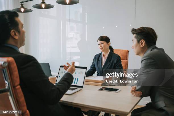 diversify mid adult asian business person discussion in meeting room - assertiviteit stockfoto's en -beelden