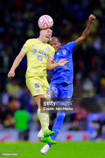 Richard Sanchez of America fights for the ball with Luis Quinones of Tigres during the 12th round match between America and Tigres UANL as part of...