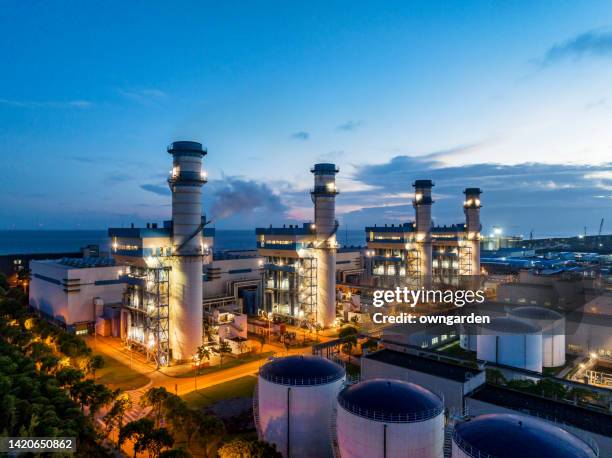 aerial view of natural gas fired electrical power plant at sunset - centrale elettrica foto e immagini stock