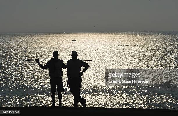 Tommy Fleetwood of England and caddie wait during the first round of the Sicilian Open at Verdura Golf and Spa Resort on March 29, 2012 in Sciacca,...