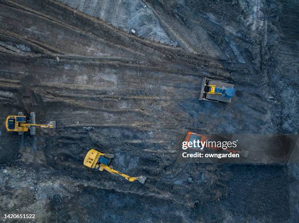 aerial view of bulldozer on land - mud truck stock pictures, royalty-free photos & images