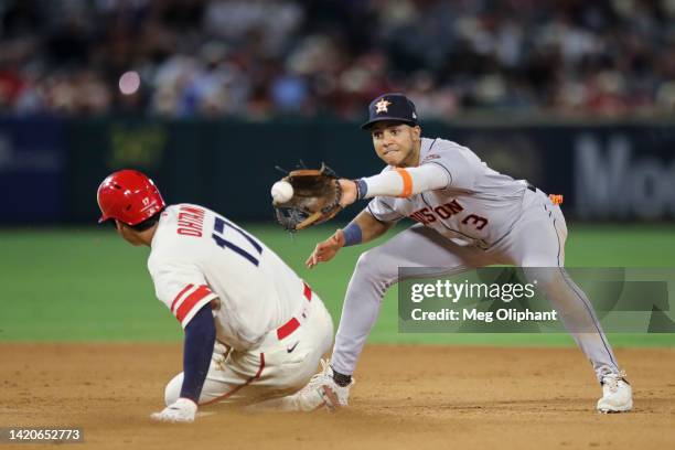 Shohei Ohtani of the Los Angeles Angels slides into second base against Jeremy Pena of the Houston Astros in the eleventh inning at Angel Stadium of...