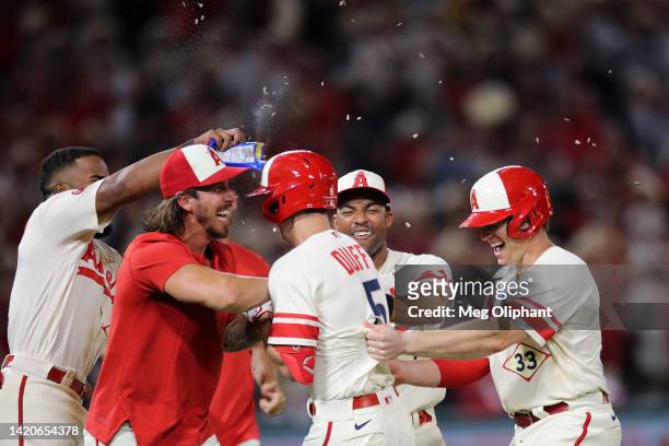The Los Angeles Angels celebrate a hit by Matt Duffy to bring in a run by Taylor Ward and win the game in the twelfth inning against the Houston...