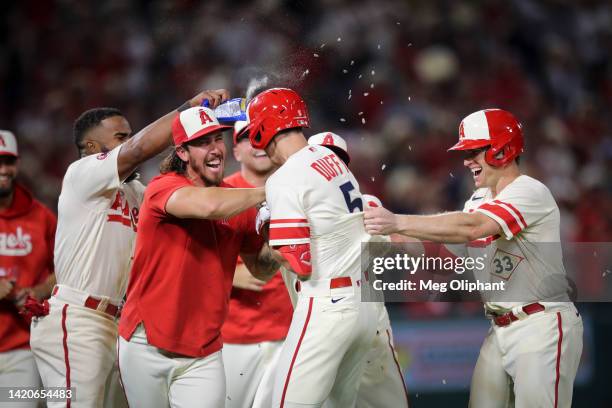 The Los Angeles Angels celebrate a hit by Matt Duffy to bring in a run by Taylor Ward and win the game in the twelfth inning against the Houston...