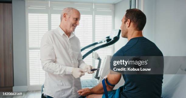 sports doctor, fitness man or blood test doping in wellness clinic, health or consulting room. healthcare professional in medical science research for athlete patient for workout or exercise training - sports training clinic 個照片及圖片檔