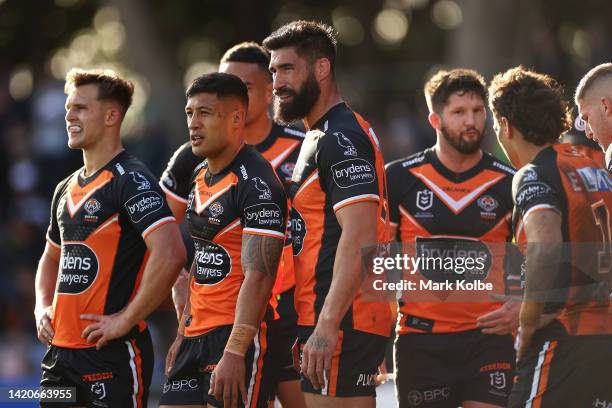 James Tamou of the Tigers and his team look dejected after a try during the round 25 NRL match between the Wests Tigers and the Canberra Raiders at...