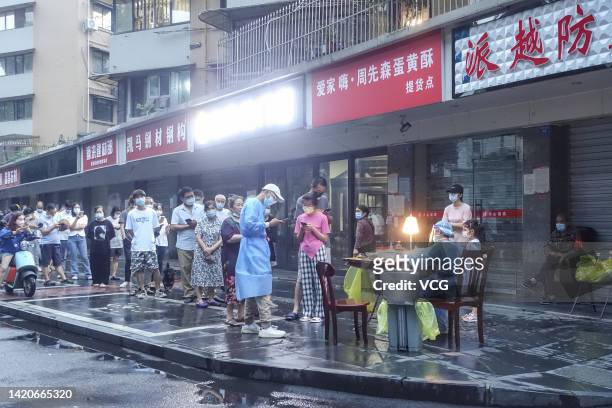 People queue up at a COVID-19 nucleic acid test site on September 2, 2022 in Chengdu, Sichuan Province of China.