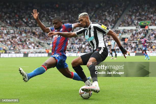 Joelinton of Newcastle United controls under pressure from Cheick Doucoure of Crystal Palace during the Premier League match between Newcastle United...