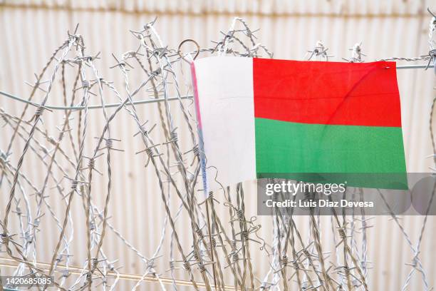 flag of madagascar on barbed wire - madagascar boa stock pictures, royalty-free photos & images