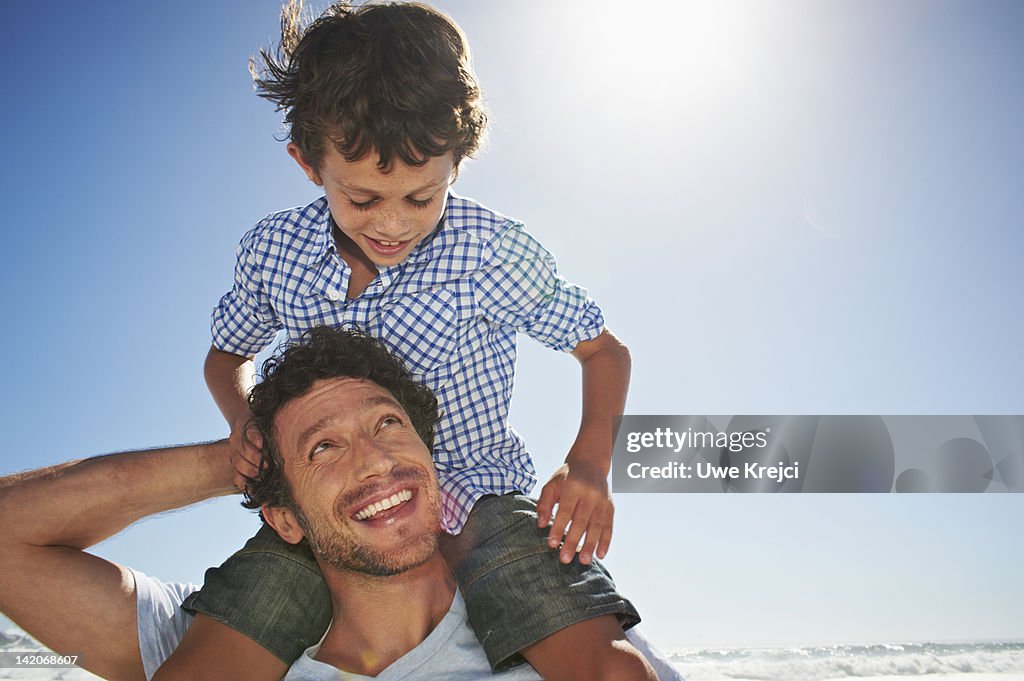 Father carrying son on shoulders