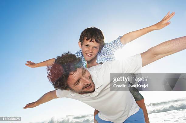 father playing with son (6 - 8 years) - 飛行機のまね ストックフォトと画像